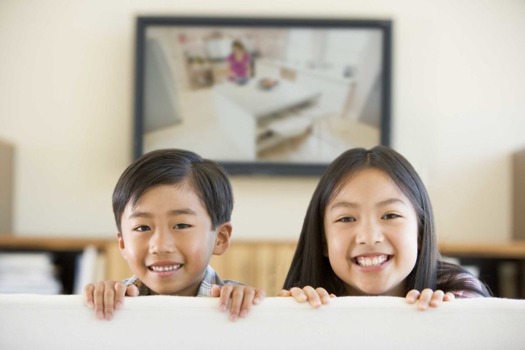 Boy and Girl on sofa watching