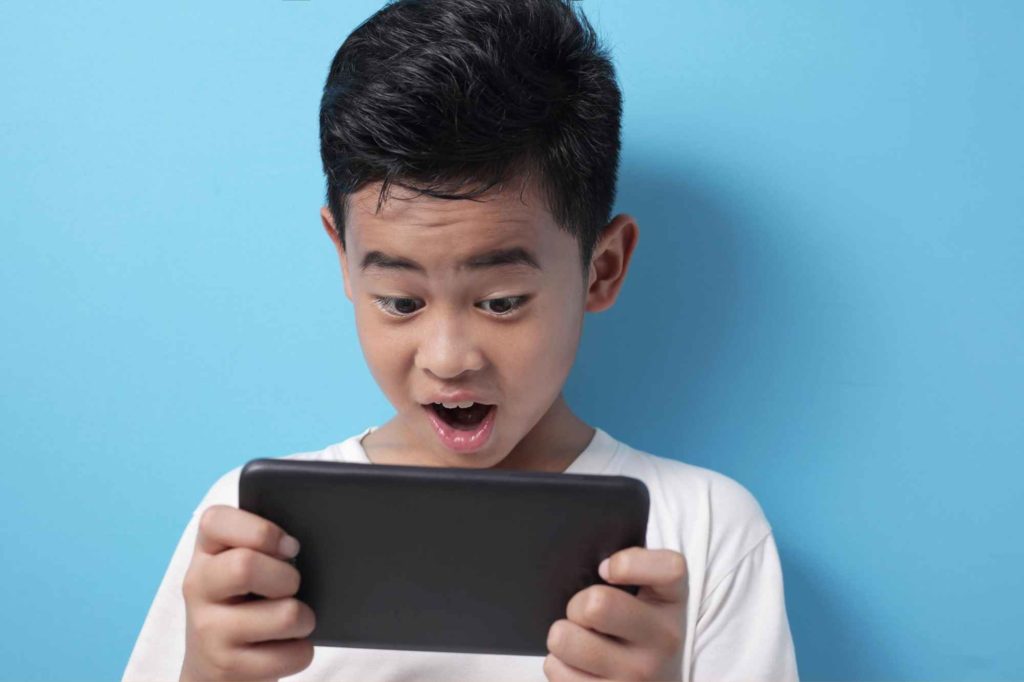 boy playing with online gaming console