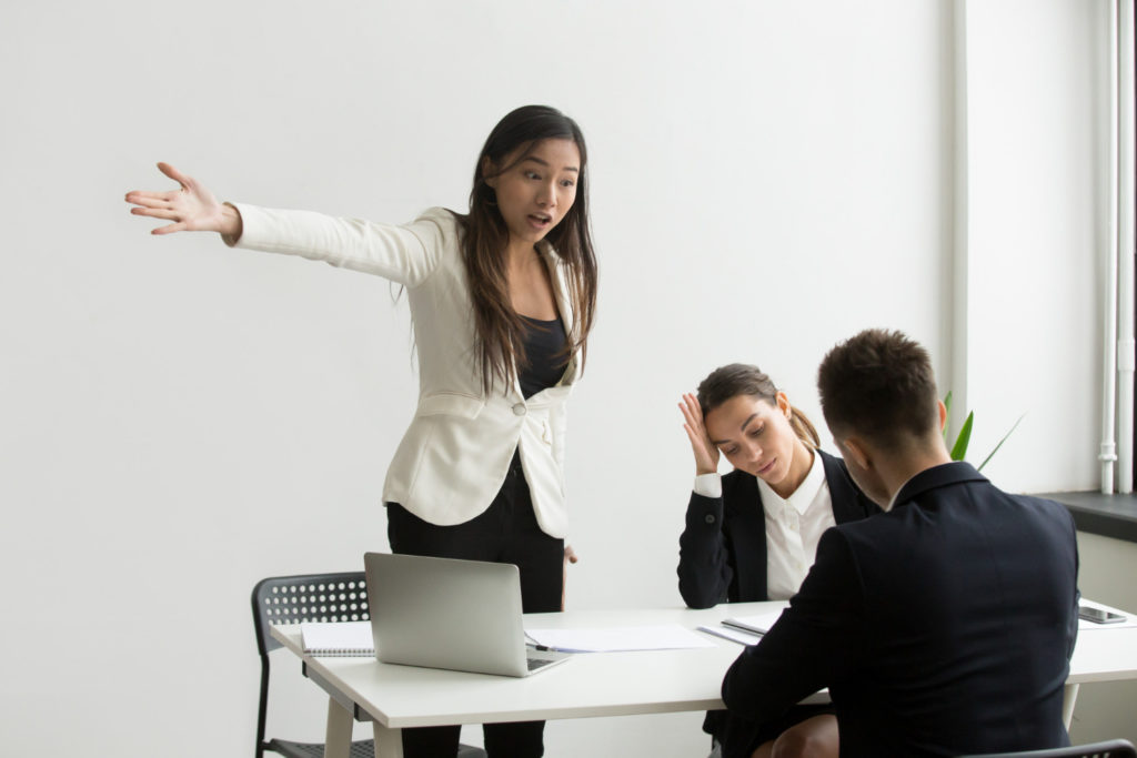 Woman shouting at colleagues - Emotional Invalidation workplace