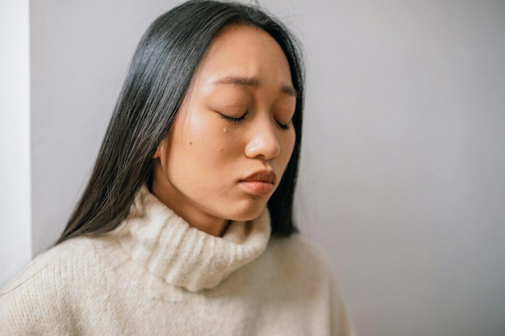 close up photo of a woman crying